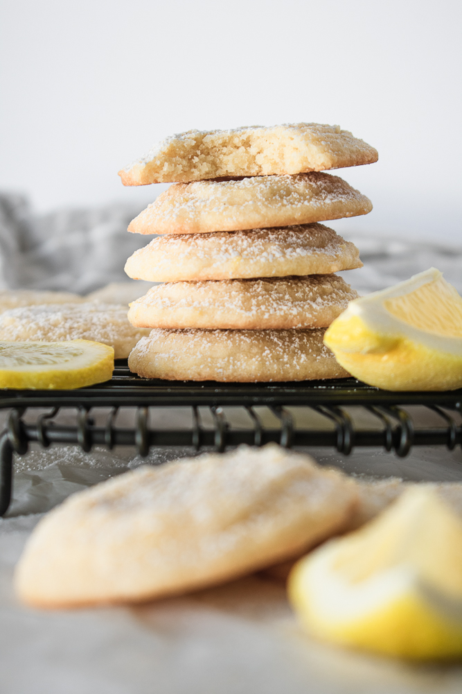 A stack of lemon cookies on a wire rack