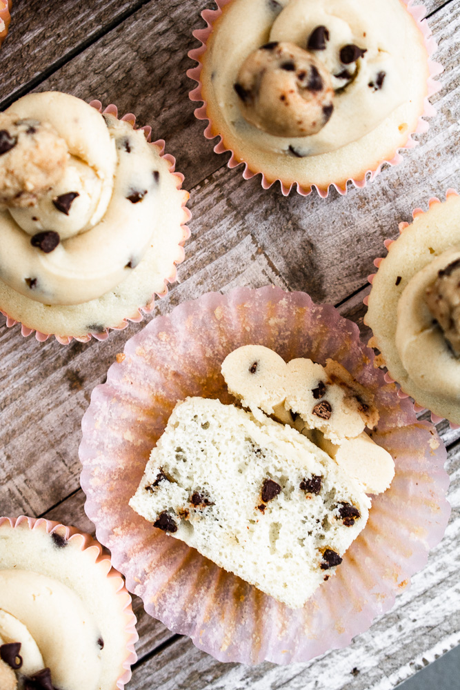 Chocolate chip cupcake sitting on a cupcake liner cut in half