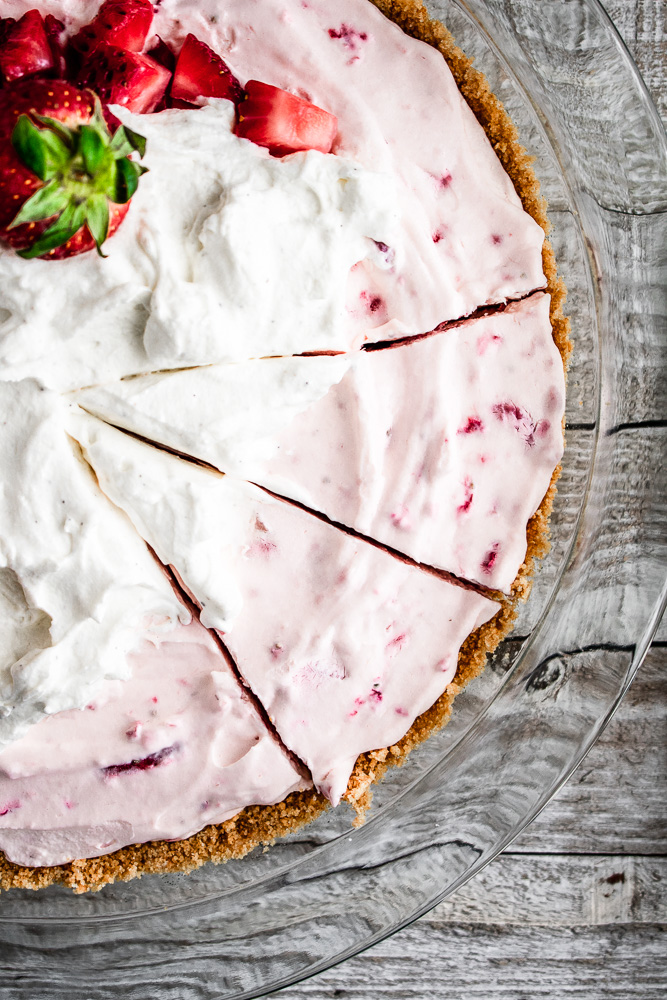Strawberry cream pie with two slices cut into it
