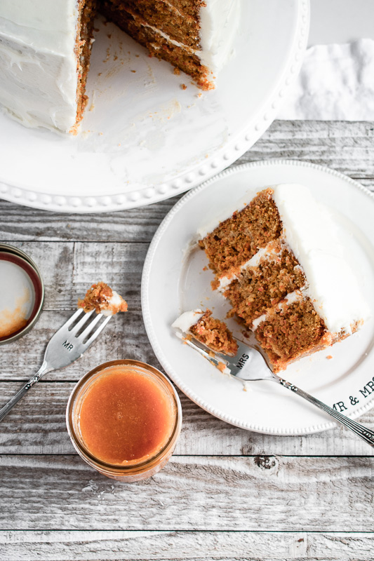 Homemade peach jam next to a slice of peach carrot cake