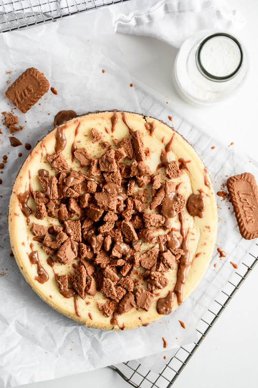 Cookie butter cheesecake with milk bottle on parchment paper