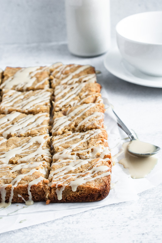 Maple peach blondies with bourbon glaze on parchment paper