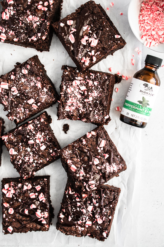 Dark chocolate peppermint brownies on white parchment paper