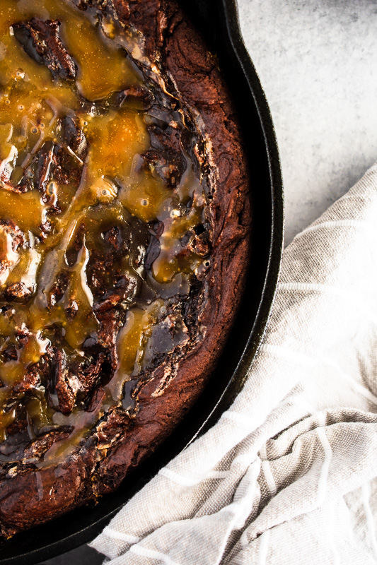 Homemade salted caramel on a skillet brownie