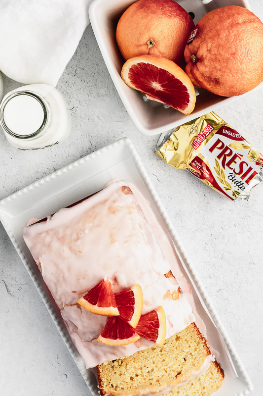 Slices of blood orange loaf cake on a white platter