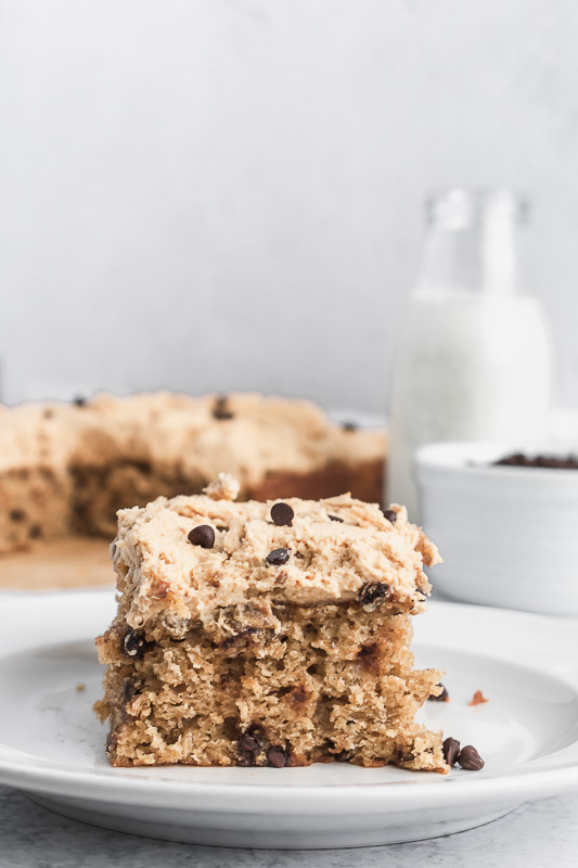 Slice of oatmeal chocolate chip cookie cake on a white plate