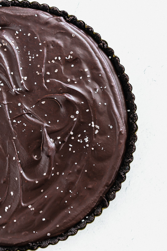 Top view of salted dark chocolate tart in a pan