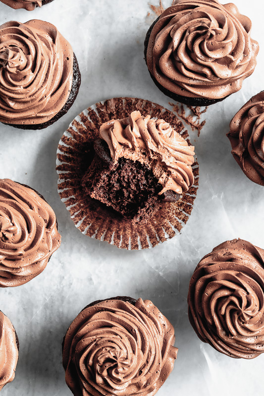 Double dark chocolate cupcake with bite taken out of it