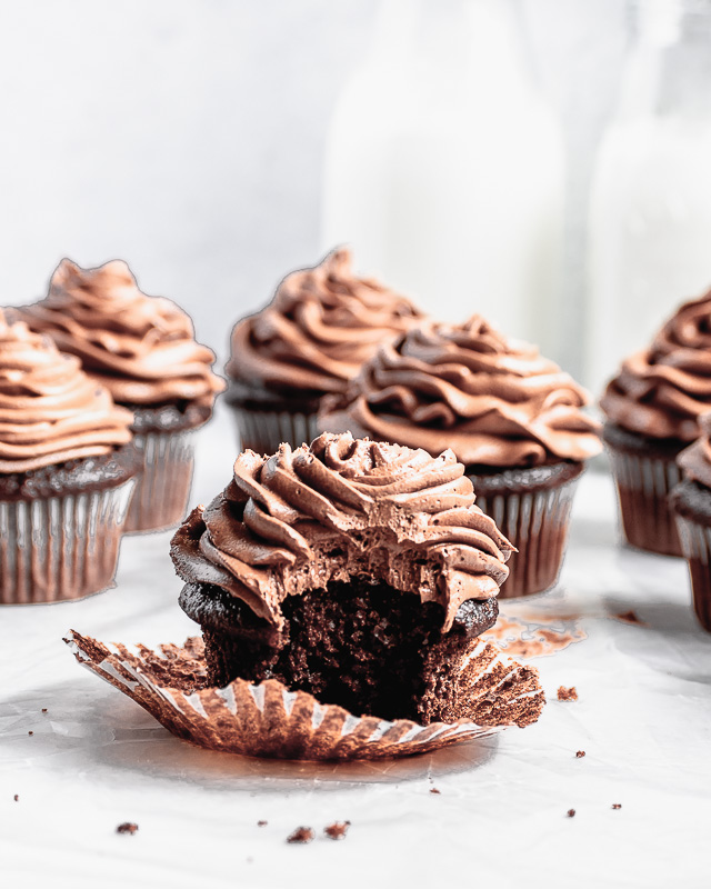 Bite taken out of double dark chocolate cupcake