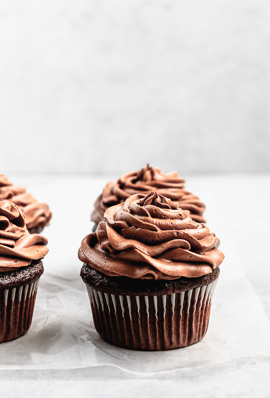 Side view of dark chocolate cupcakes with dark chocolate buttercream