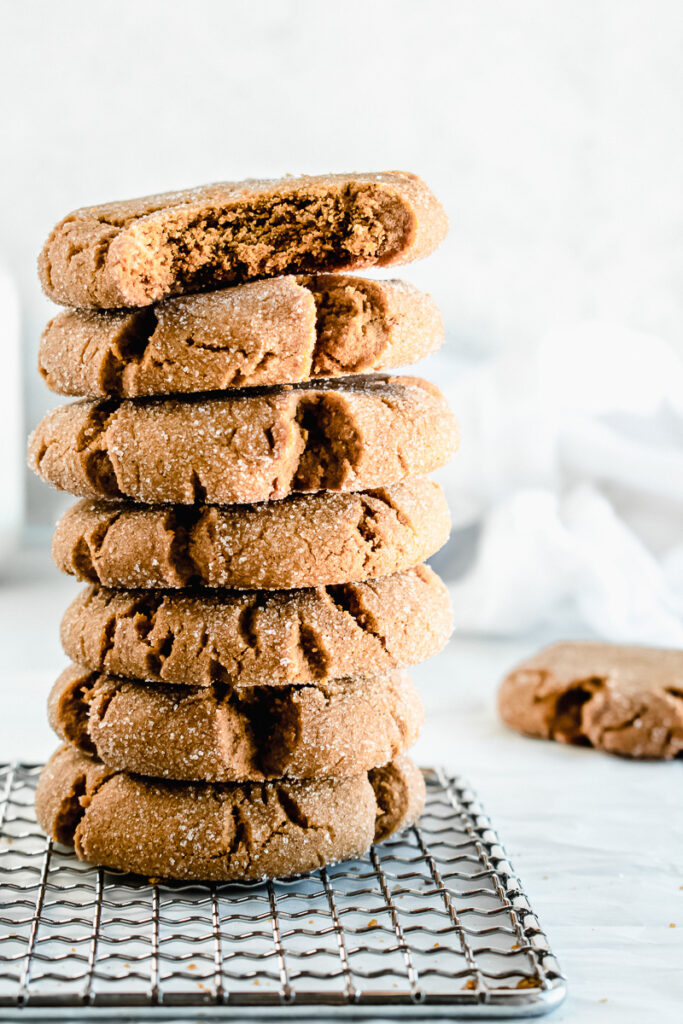 Chewy ginger molasses cookies stacked on top of each other.