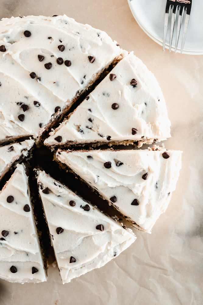 Slices of chocolate chip layer cake on parchment paper