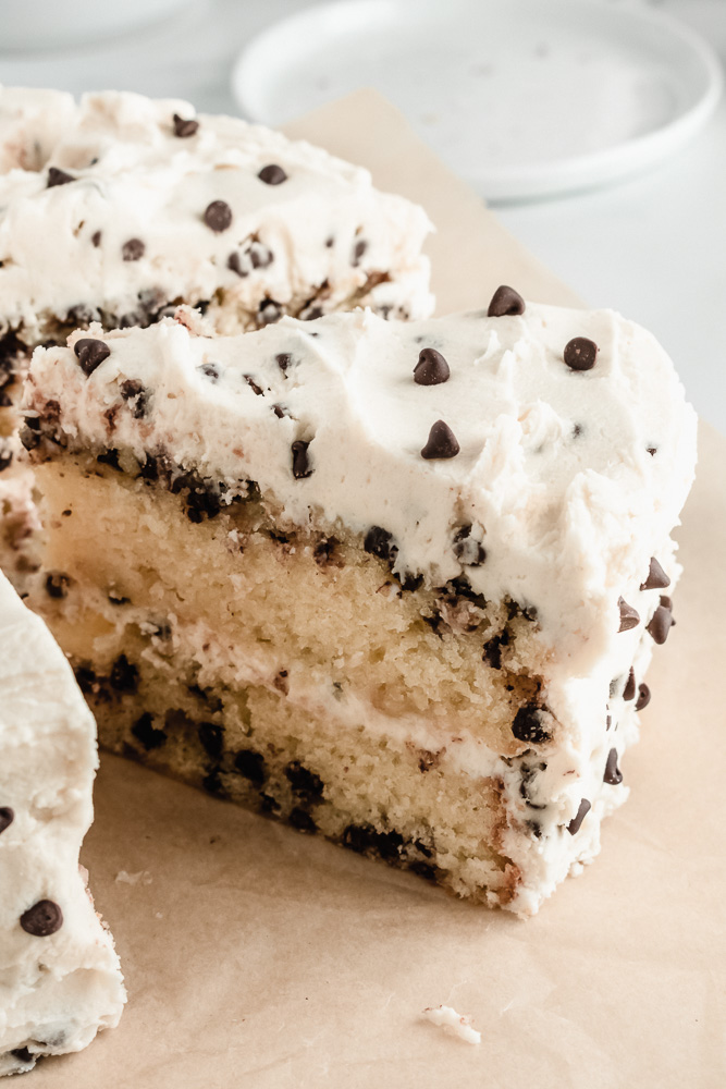 Slice of chocolate chip layer cake with brown sugar buttercream and mini chocolate chips