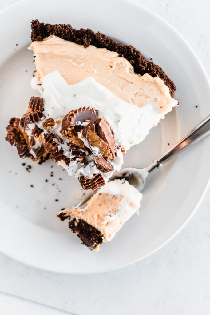 Slice of homemade peanut butter pie on a white plate