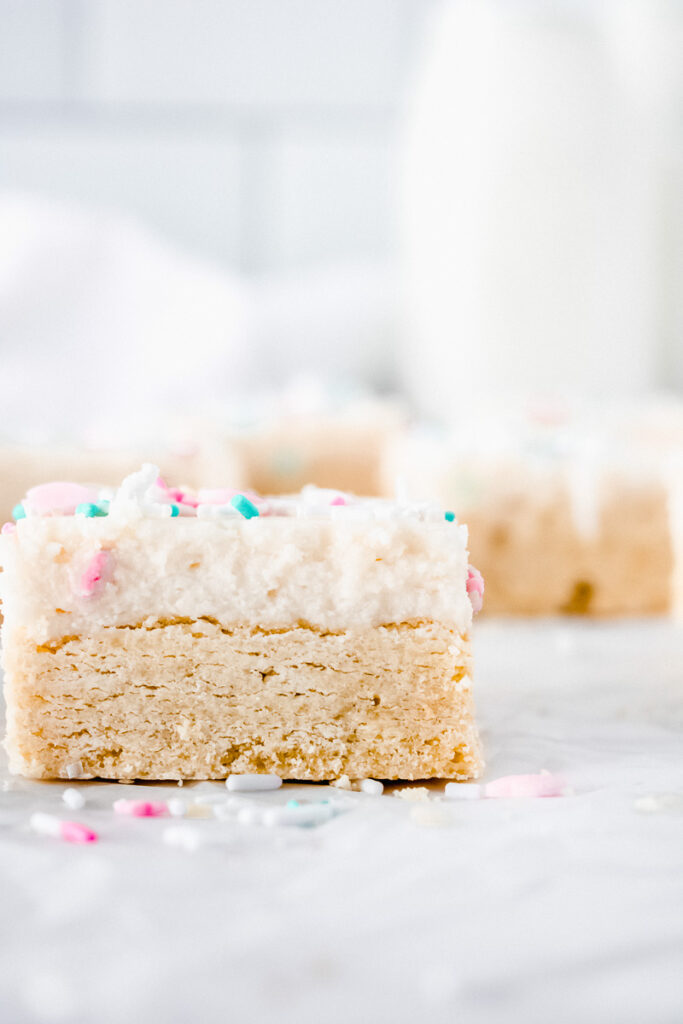 Lemon sugar cookie bar on white parchment paper