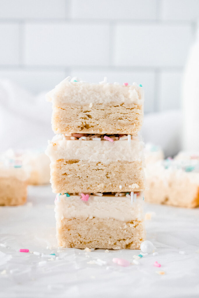Three lemon sugar cookie bars stacked on top of each other.