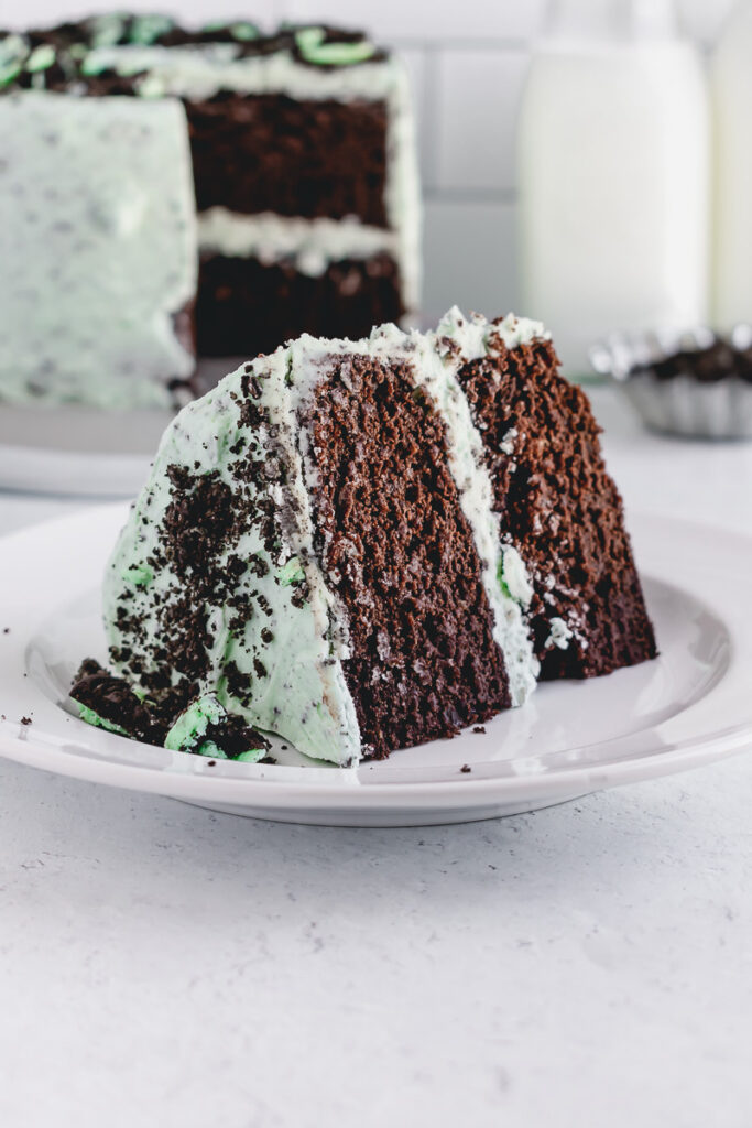 Slice of mint chocolate grasshopper cake on a white plate