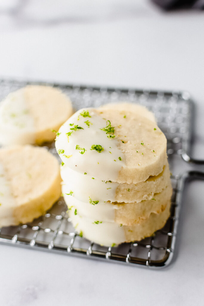 Stack of key lime pie cookies on a metal cooling rack