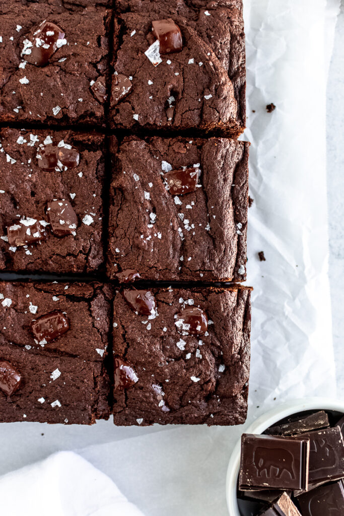 Sliced espresso brownies on white parchment paper